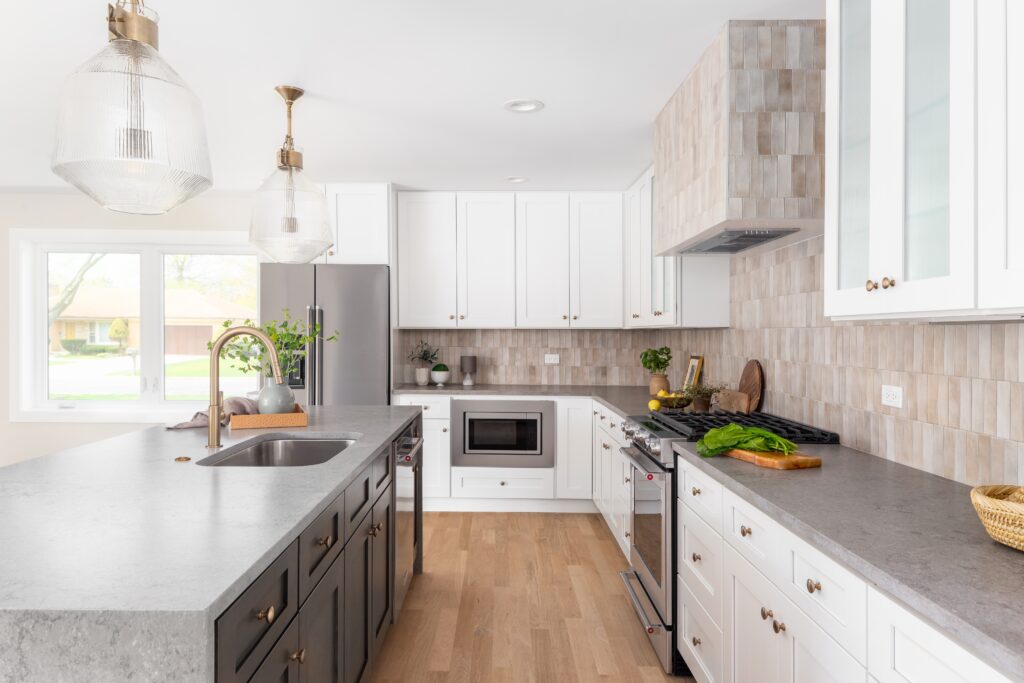 A,White,Kitchen,Detail,With,Stone,Countertops,,Gold,Light,Fixtures