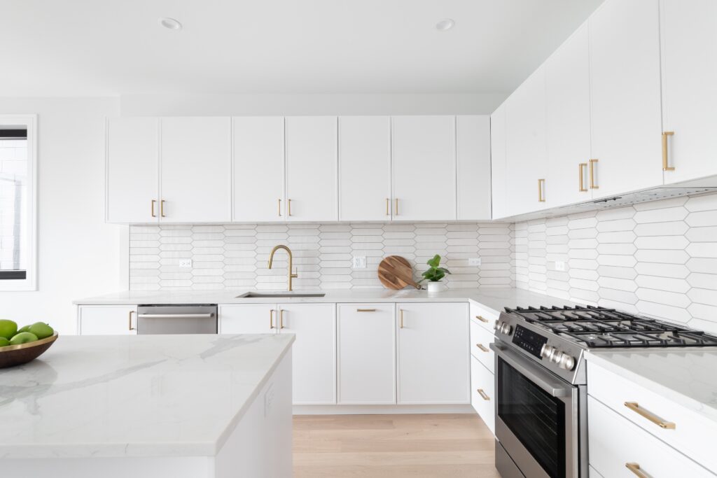 A,Beautiful,Kitchen,Detail,With,White,Cabinets,,A,Gold,Faucet,